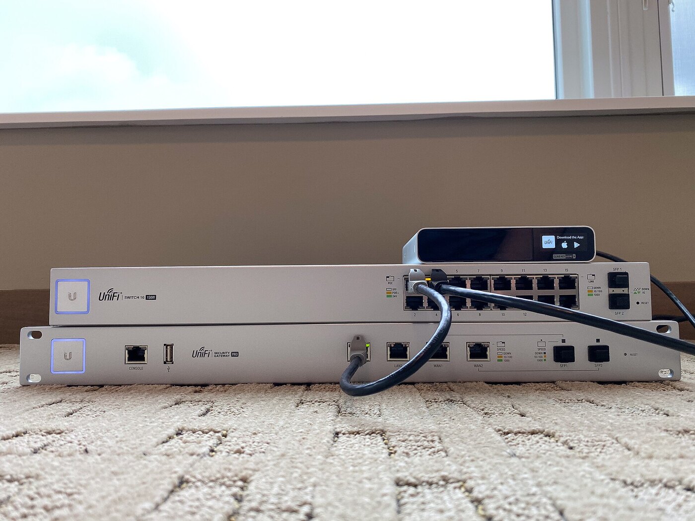 Ubiquiti UniFi security gateway and switch stacked together, the class of edge tech infrastructure targeted in the residential proxy campaign