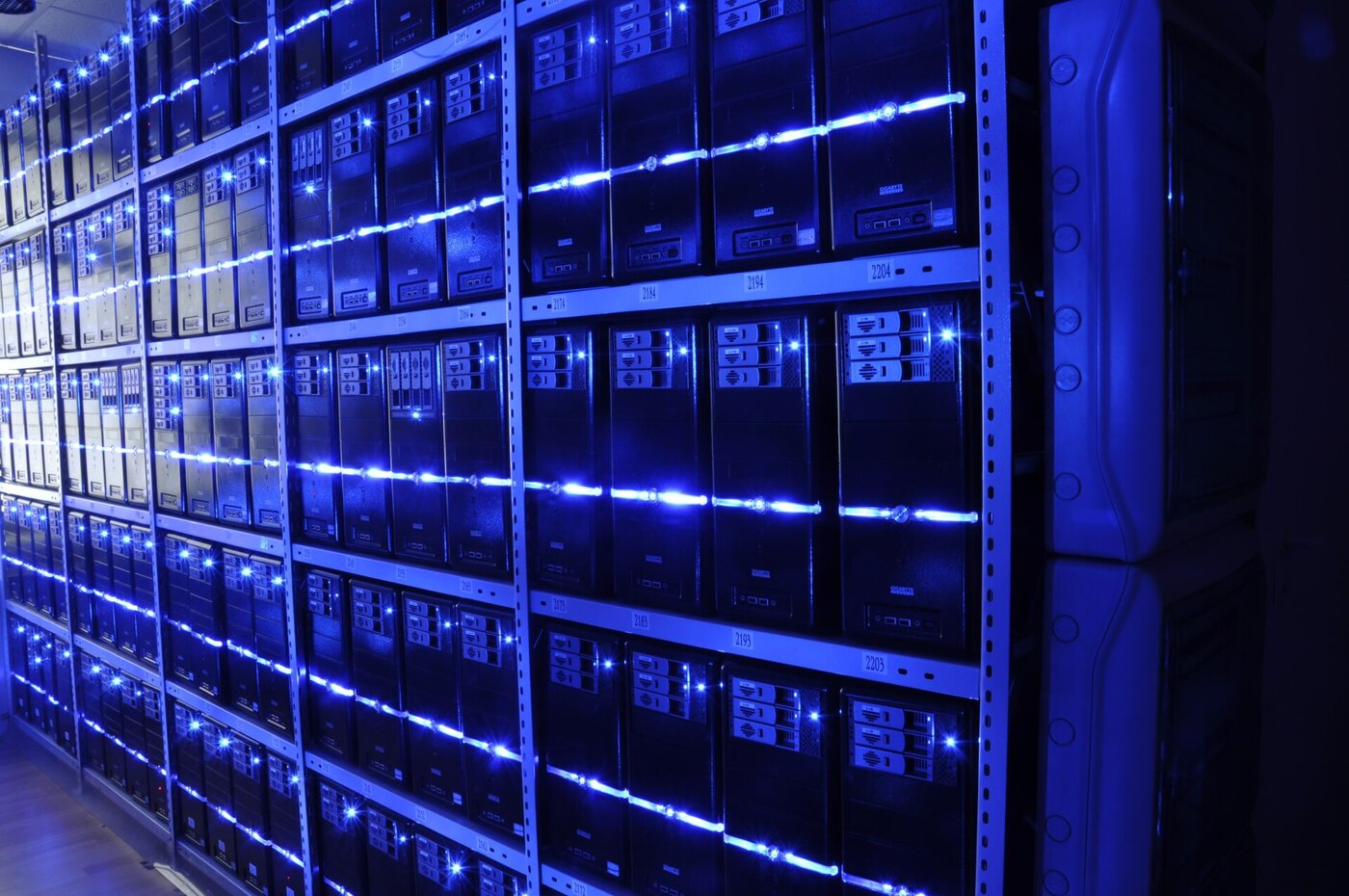 Densely packed server racks in a data centre, the kind of multi-tenant tech infrastructure where a WebAssembly sandbox escape affects many tenants per host